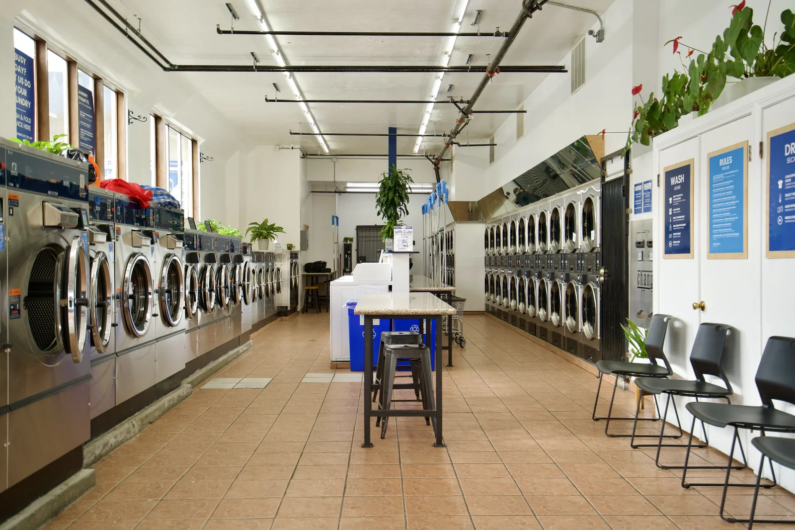 Folding area, machines and seating at The Laundry Hub SF