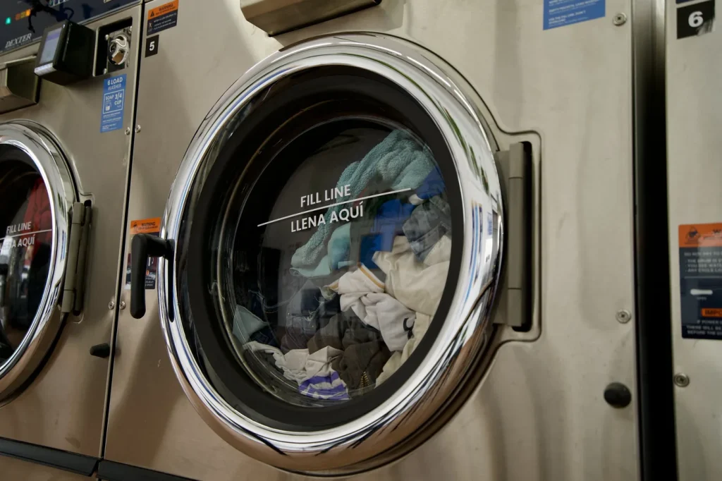 Linen washing on its own inside a commercial machine at The Laundry Hub SF