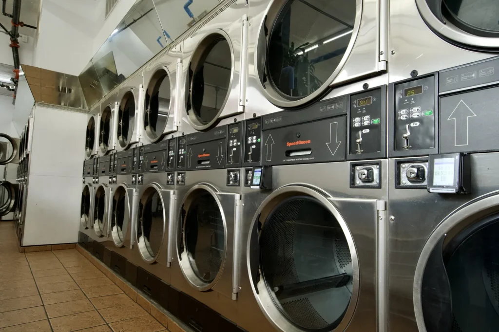 Row of stacked dryers down the tiled aisle at The Laundry Hub SF