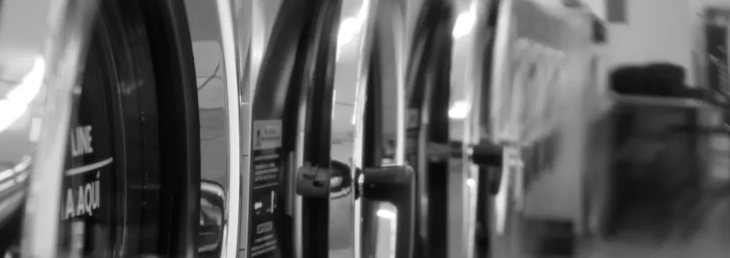 Black and white close up of the washer drums at The Laundry Hub SF